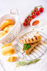 delicious bratwurst with ketchup and fresh rolls