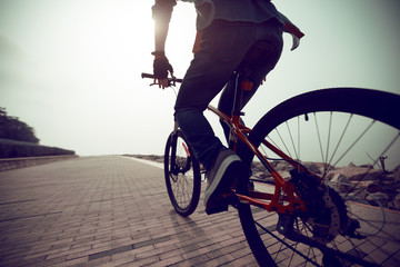 cyclist riding mountain bike in the sunrise coast