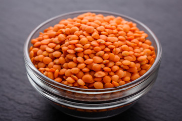 raw lentils on a dark stone background