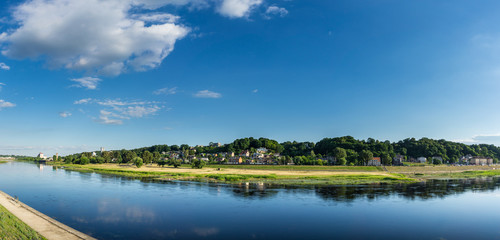 Lithuania, XXL panorama of Kaunas river reflecting houses, trees and clouds