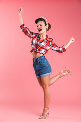 Happy young pin-up woman posing isolated