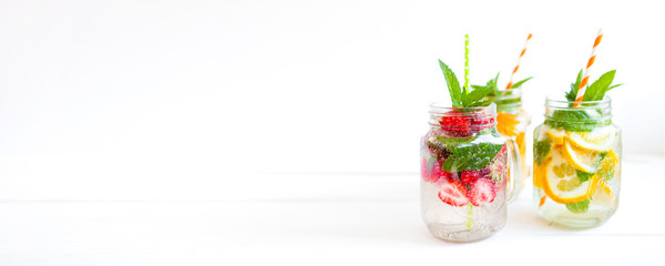 Homemade iced lemonade with mint, summer fruits and berries in a mason jar. Copy space background - 211901928