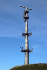 Fototapeta na wymiar Radar antenna on tall mast at the port of rotterdam to guide ships.