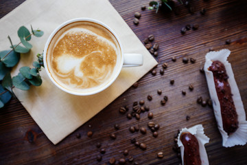 Cappuccino, eclairs and flowers.