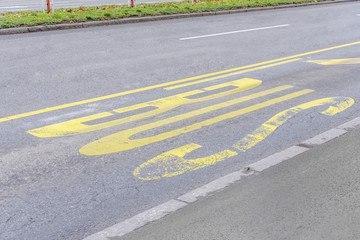 Obraz premium Yellow bus stop painted pattern on asphalt road in the city