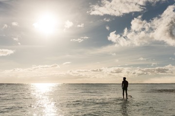 Male surfer surfing with surfboard in the sea