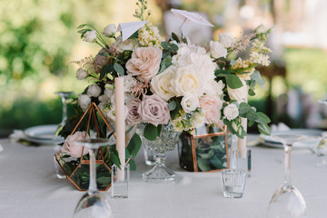 Magnificent, volume bouquets of flowers in high glass vases