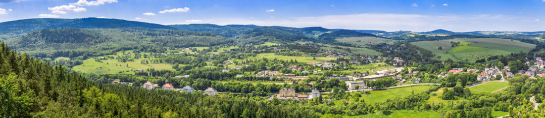 Fototapeta na wymiar Aerial view of countryside landscape in mountain valley, panorama of town and houses in nature