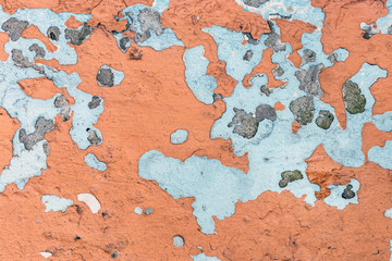 Old painted wall with cracks. Lot of previous paint layers revealed. Retro aged background