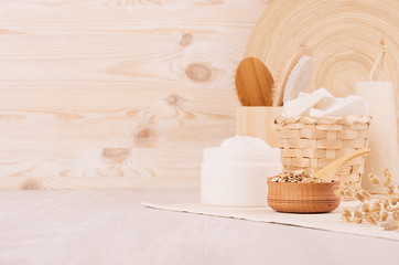 Rustic white homemade cosmetics set of naturel products for body care and bath accessories with spikelets in light beige wood interior, copy space.