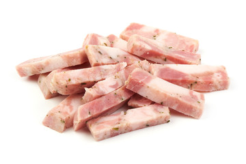 A portion of sliced pork bacon, ingredient for cooking, isolated on white background. Close-up.