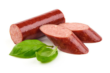Sliced smoked sausage with fresh basil leaves, isolated on white background. Close-up.