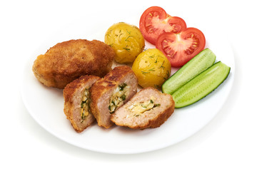 Cutlets cordon bleu with potatoes, tomatoes and cucumbers, isolated on white background.