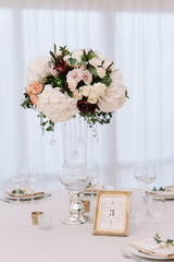 Magnificent, volume bouquets of flowers in high glass vases