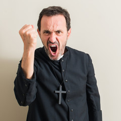 Senior priest religion man annoyed and frustrated shouting with anger, crazy and yelling with...