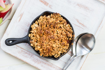 Homemade cooked rhubarb and apple crumble with oatmeal