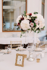 Magnificent, volume bouquets of flowers in high glass vases