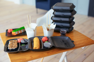 rolls and Udon noodles on a wooden table