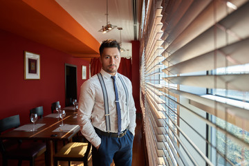  thoughtful young successful male entrepreneur in suit resting after business meeting.confident...