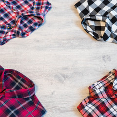 Four multi-colored checkered women's shirts lying neatly folded