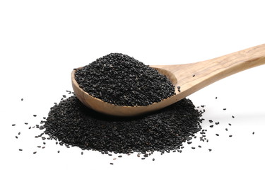Black organic sesame seeds in wooden spoon isolated on white background