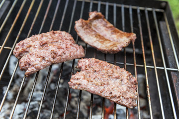 Sausages cook on the grill