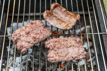 Sausages cook on the grill
