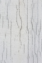 Texture of white dirty cracked wall. Small straight cracks. Direct fracture on painted surface. Cells fissure