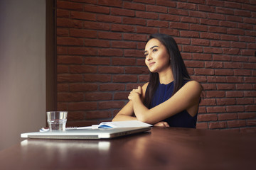  positive asian businesswoman positive female reading news and making notes satisfied with productive job in coffee shop with wifi