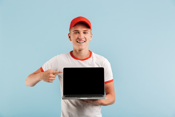 Portrait of a smiling casual teenage boy in red cap