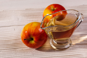 apple vinegar on a wooden rustic background