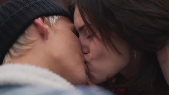 passionate kiss of a young couple close-up.