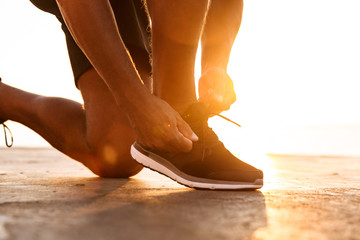 Close up of a sportsmantying his shoelaces