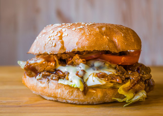 Delicious and juicy burger with appetizing meatball and fresh vegetables