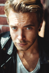 Fashion portrait of an attractive man inside industrial building
