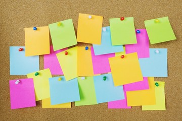 collection of colorful variety post it. paper note reminder sticky notes pin on cork bulletin...
