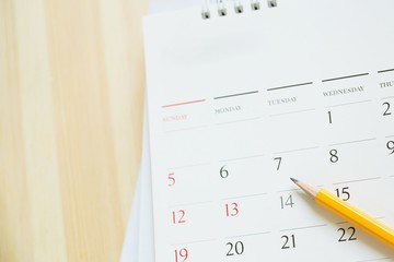 Close up Calendar page number. pencil yellow to mark the desired date to remind memory on the...