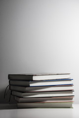 Stack of book on a white desk