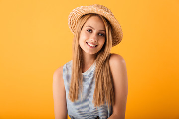 Portrait of a smiling young blonde woman in summer hat