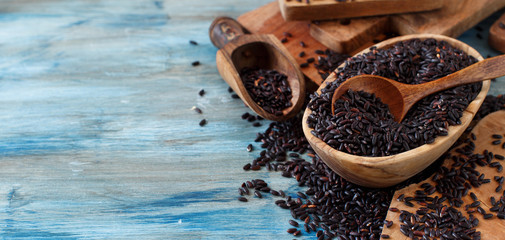 Black rice in a bowl with a spoon