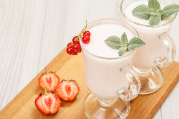 Delicious strawberry yogurt with mint leaves in glasses