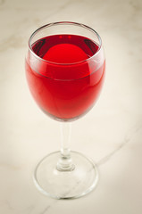 Wine over white marble background/Red wine over white marble background. Selective focus