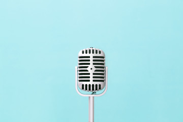 Retro microphone on soft green wall background