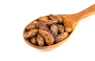 Haricot beans in a wooden spoon  isolated on white background