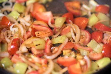 Green peppers onion and tomato on the grilled pan. Healthy breakfast.
