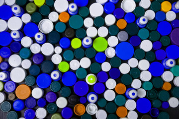 Conception of plastic processing for ecology or charity. Collection of various colorful plastic screw caps. Useful as background
