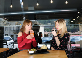 pretty young women drinking in cafe