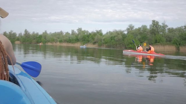 Young couple having good time on canoe on the river