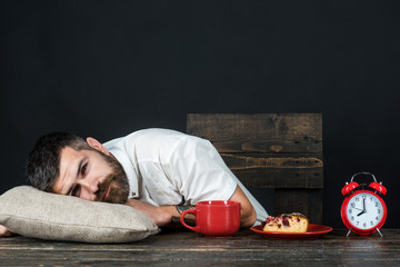 Tired man. Bearded man sleeping at home with head on pillow. Man falling asleep during breakfast...