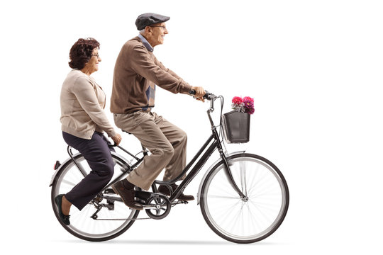 Seniors riding a bicycle together